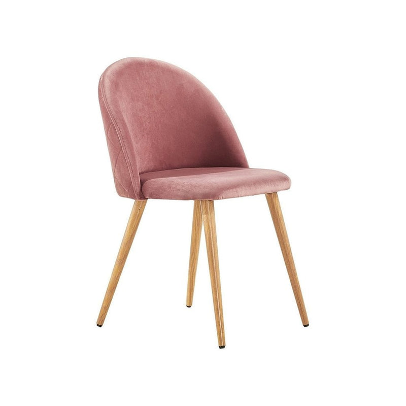 Scandinavian oak dining table set with velvet chairs featuring a pink velvet chair on wooden legs.