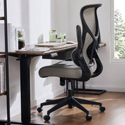 Modern office chair in front of a desk with a window in the background