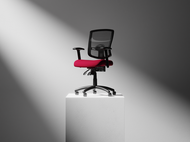 A modern office chair with a black mesh back, black armrests, and a bright red seat cushion, displayed on a white pedestal against a gray background with dramatic spotlighting.