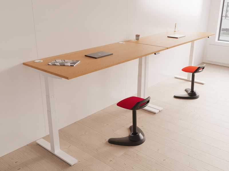 Spry Task Operator Stool – Black Fabric, lifestyle shot at height-adjustable desk